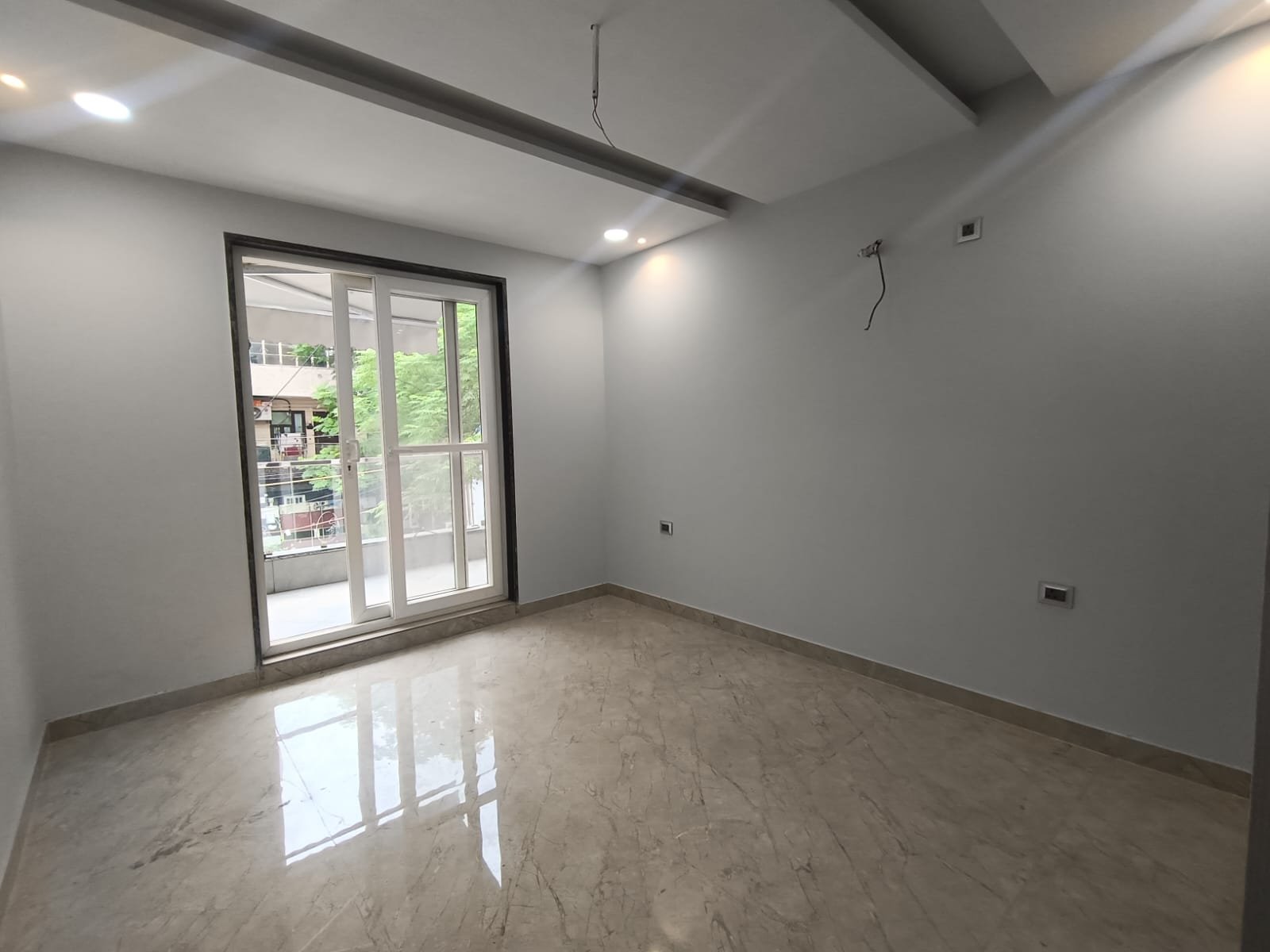 Front view of a newly renovated 3 BHK DDA MIG Flat on the first floor in B3B Block Janakpuri, featuring dual balconies, modern design, and corner location.