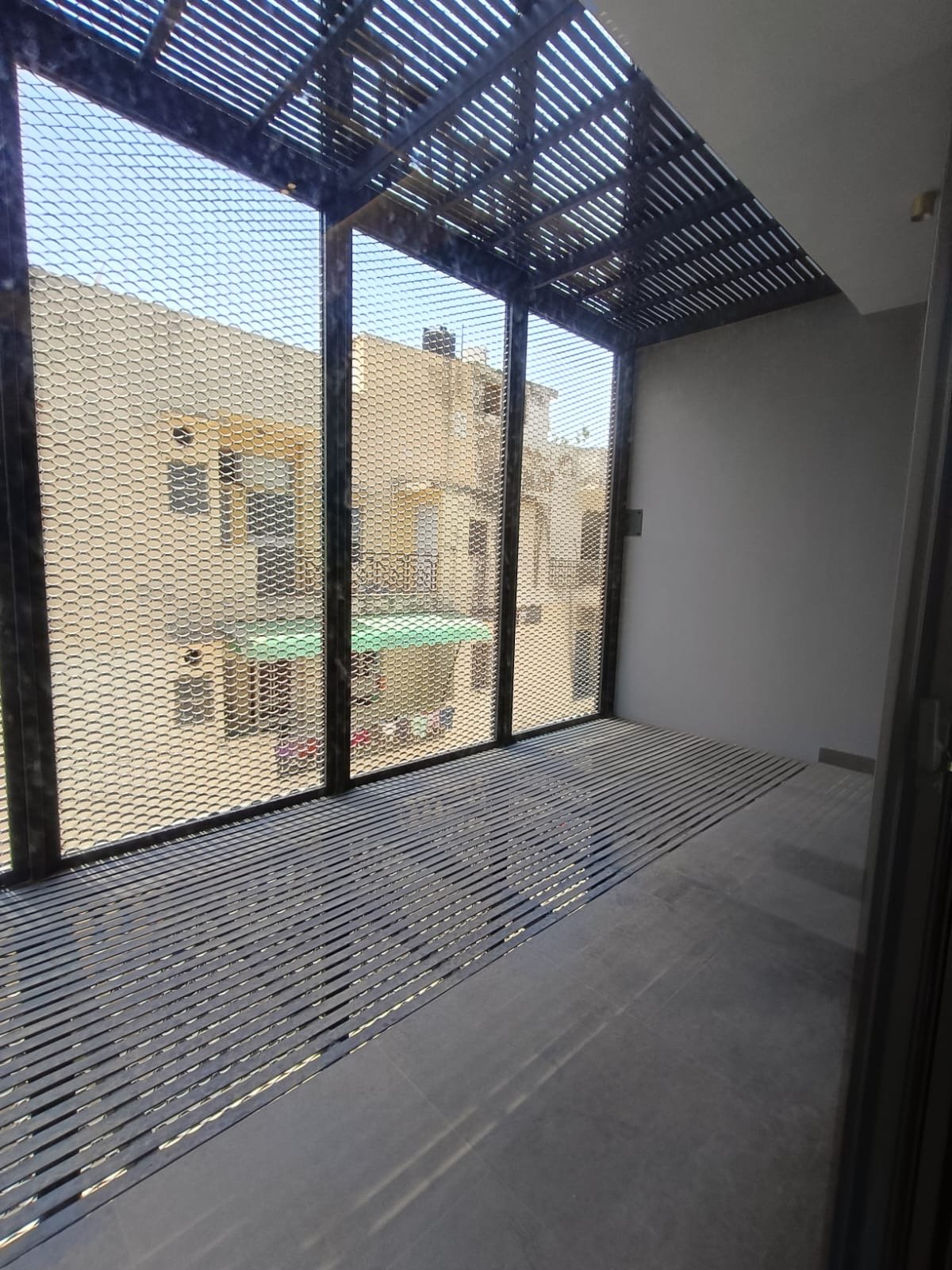 Rear balcony with bird mesh protection and ventilation Janakpuri home